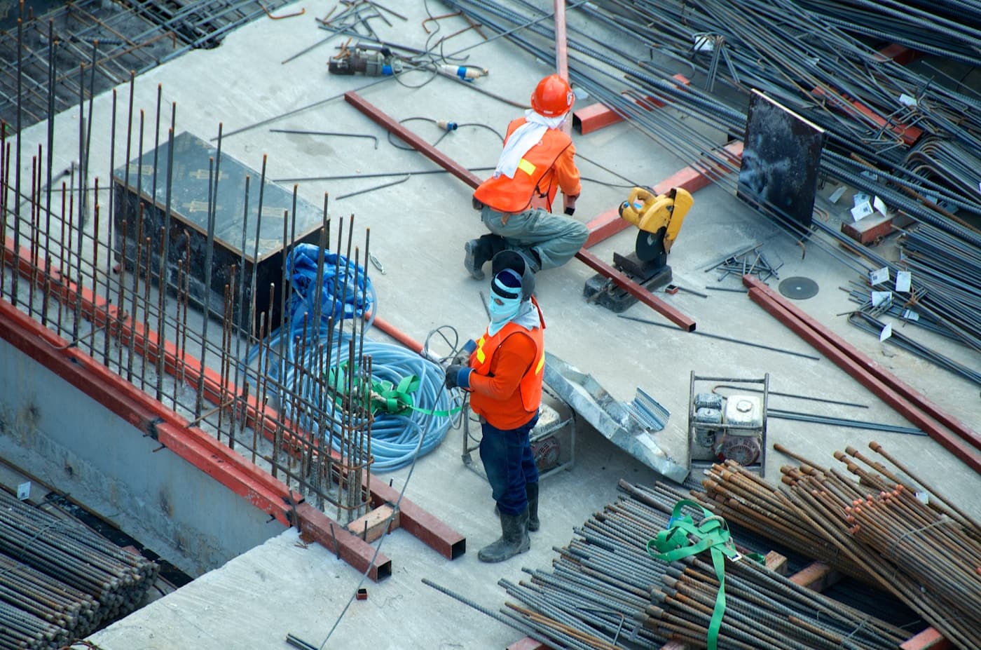 Field engineer in safety gear reviewing a work package on a tablet at a utility site